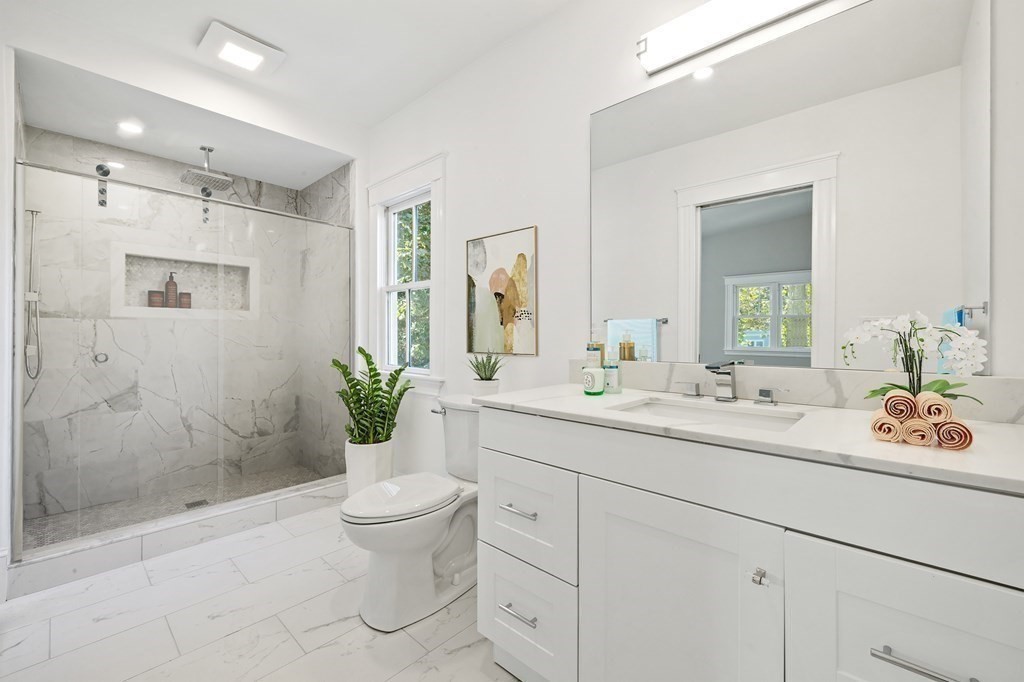 3 Dexter Road Wellesley, MA 02482 - Photo 27 of 40 a bathroom with a sink a toilet and shower