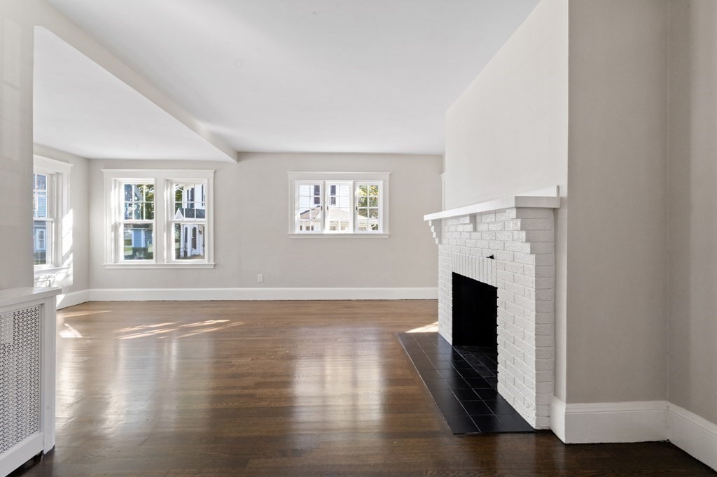 3 Dexter Road Wellesley, MA 02482 - Photo 6 of 40 a view of empty room with wooden floor and fireplace