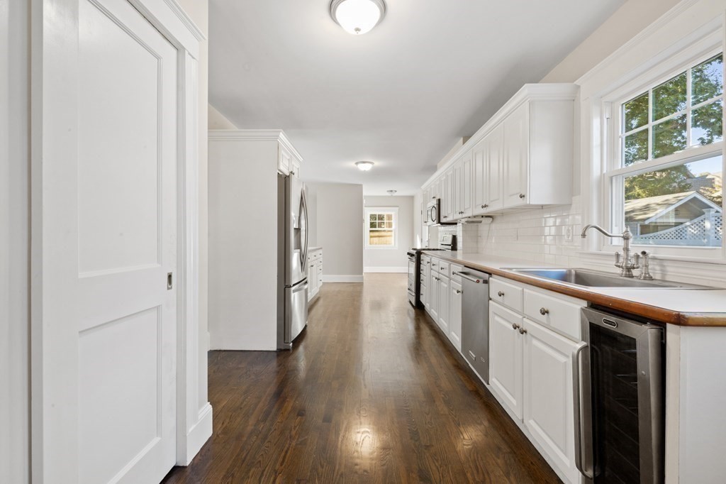3 Dexter Road Wellesley, MA 02482 - Photo 9 of 40 a kitchen with sink a refrigerator and wooden floor
