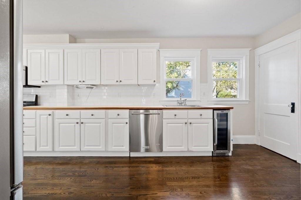 3 Dexter Road Wellesley, MA 02482 - Photo 10 of 40 a kitchen with stainless steel appliances granite countertop a sink window and cabinets with wooden floor