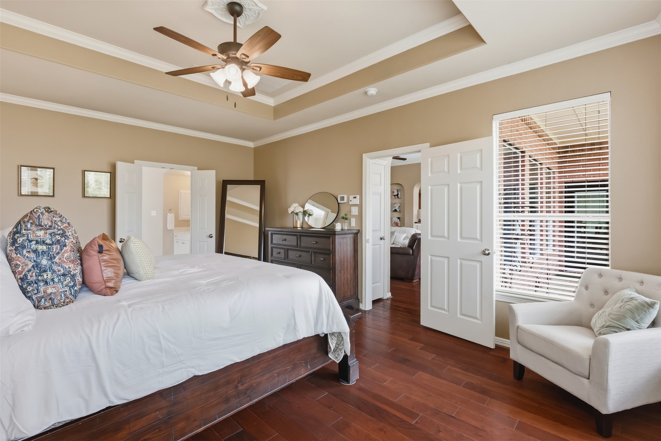 20722 Windrose Bend Drive Spring, TX 77379 - Photo 21 of 50 Your large primary bedroom features neutral paint, a dropped ceiling fan, and double doors to access to your private, ensuite bathroom.