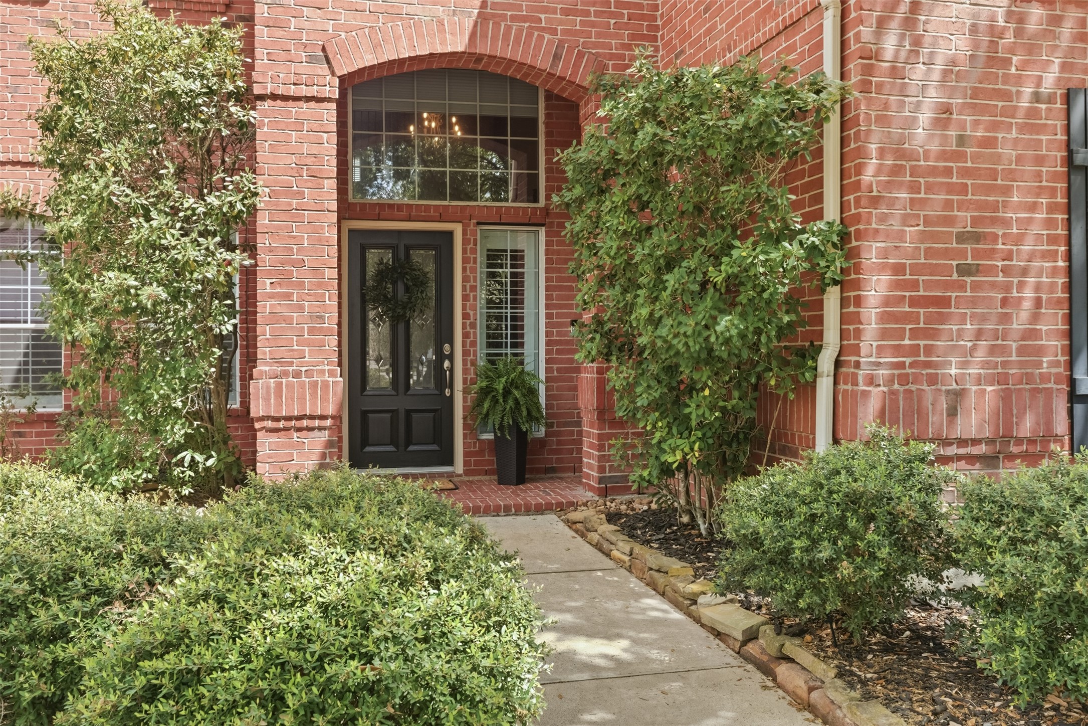 20722 Windrose Bend Drive Spring, TX 77379 - Photo 3 of 50 This charming home is perfect for those with a green thumb or anyone who appreciates a lush landscape, offering easy maintenance with many perennial plants to keep it effortlessly beautiful each year.