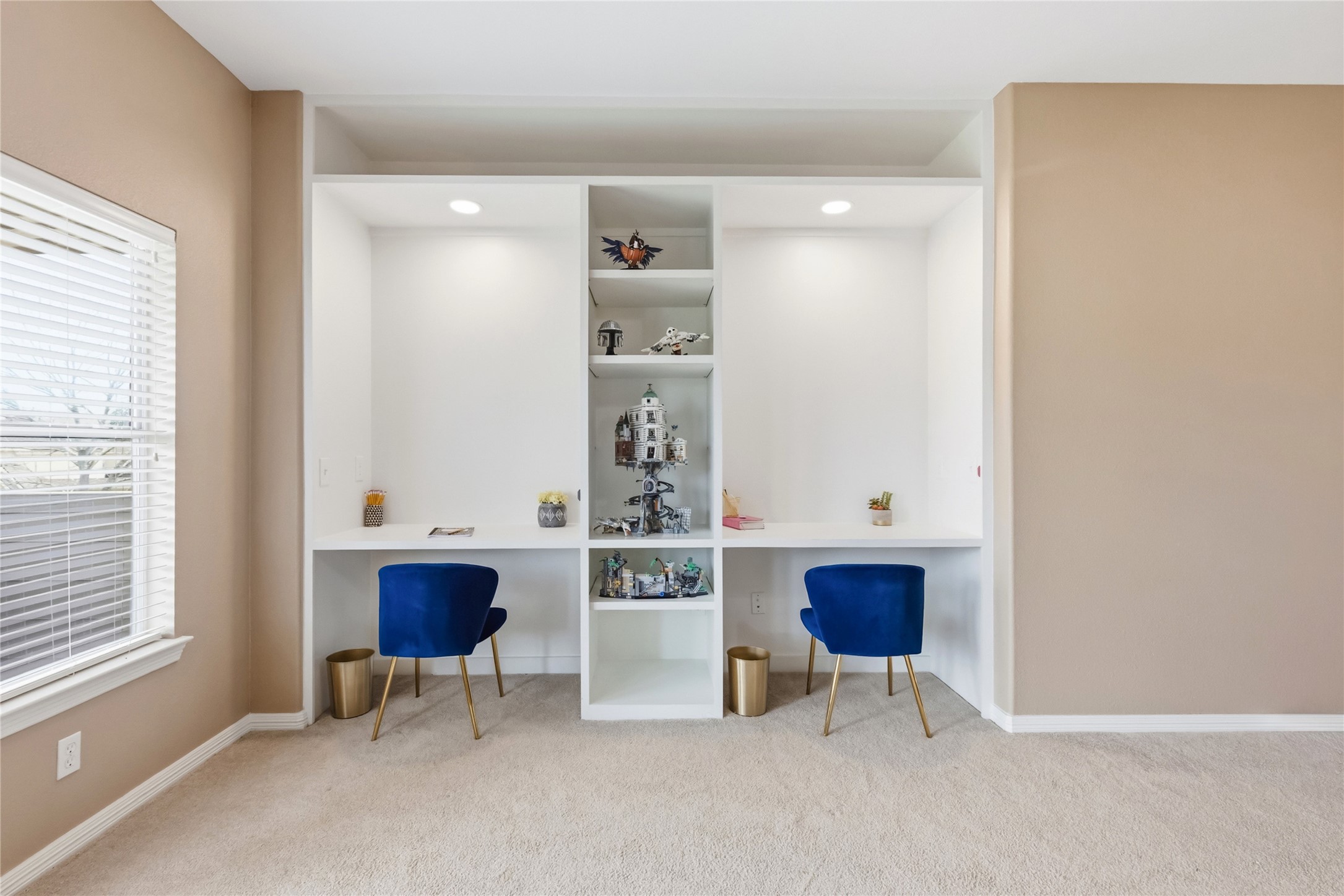 20722 Windrose Bend Drive Spring, TX 77379 - Photo 33 of 50 A well-lit study nook, work station, or perhaps even a Lego building station, is offered with this custom built-in white shelving unit, featuring two individual workspaces. It's ideal for a home office or study area.