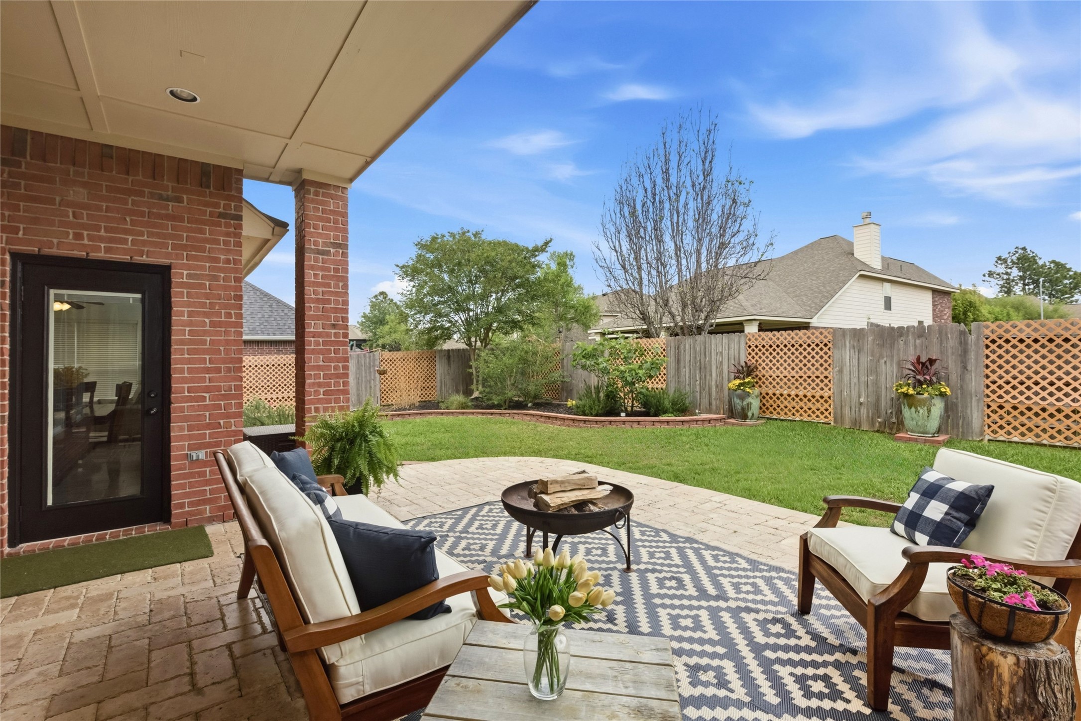 20722 Windrose Bend Drive Spring, TX 77379 - Photo 4 of 50 Take in the evening air on your spacious, covered back patio with exquisite travertine tile, or, admire the idyllic garden beds brimming with all sorts of fruitful vegetation including rosemary, gold lantana, canna lilies, 2 fig trees, & a plum tree.