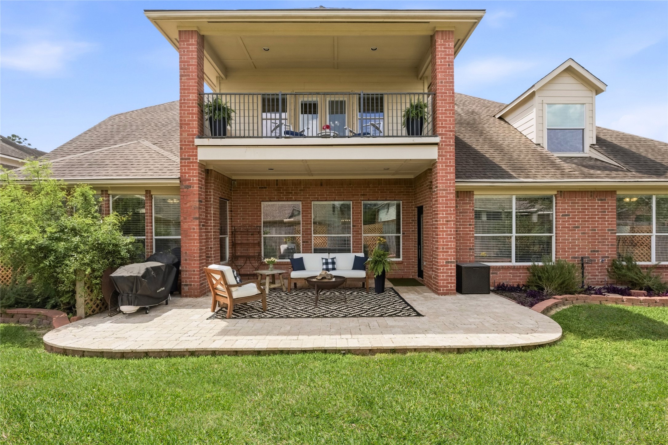 20722 Windrose Bend Drive Spring, TX 77379 - Photo 5 of 50 Experience the perfect blend of indoor-outdoor living with this home’s expansive back patio and inviting covered balcony, all enhanced by east-facing walls of windows that flood the space with uplifting morning sunlight.