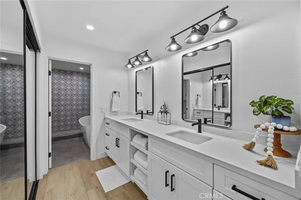 a spacious bathroom with a double vanity sink mirror and toilet