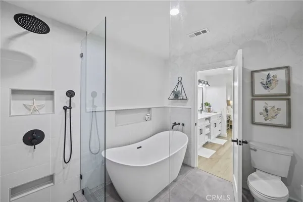 a bathroom with a toilet bathtub and shower