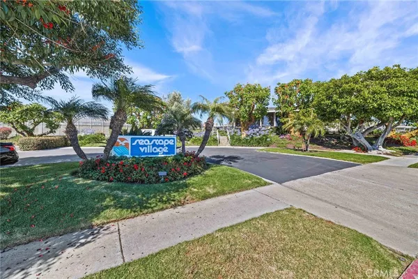 a view of a white house with a yard