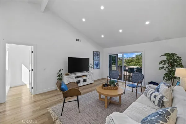a living room with furniture a flat screen tv and a large window