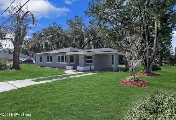 a front view of house with yard and green space