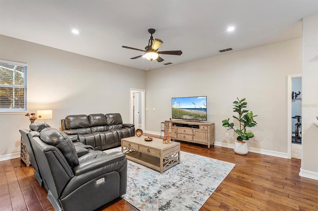 5713 Oak Lake Trail Oviedo, FL 32765 - Photo 11 of 52 a living room with furniture a flat screen tv and a potted plant
