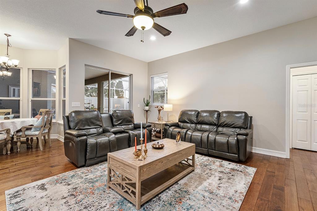 5713 Oak Lake Trail Oviedo, FL 32765 - Photo 12 of 52 a living room with furniture a flat screen tv and a table