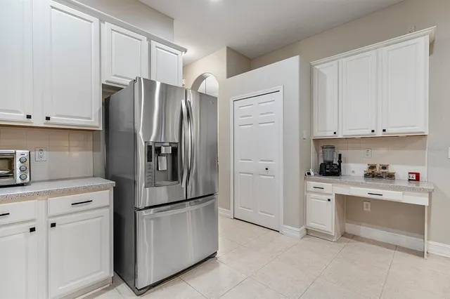 a kitchen with stainless steel appliances a refrigerator sink and cabinets