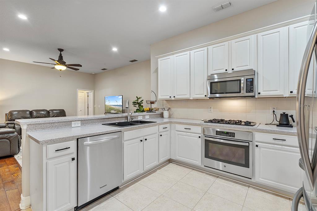 5713 Oak Lake Trail Oviedo, FL 32765 - Photo 16 of 52 a kitchen with cabinets stainless steel appliances and a sink