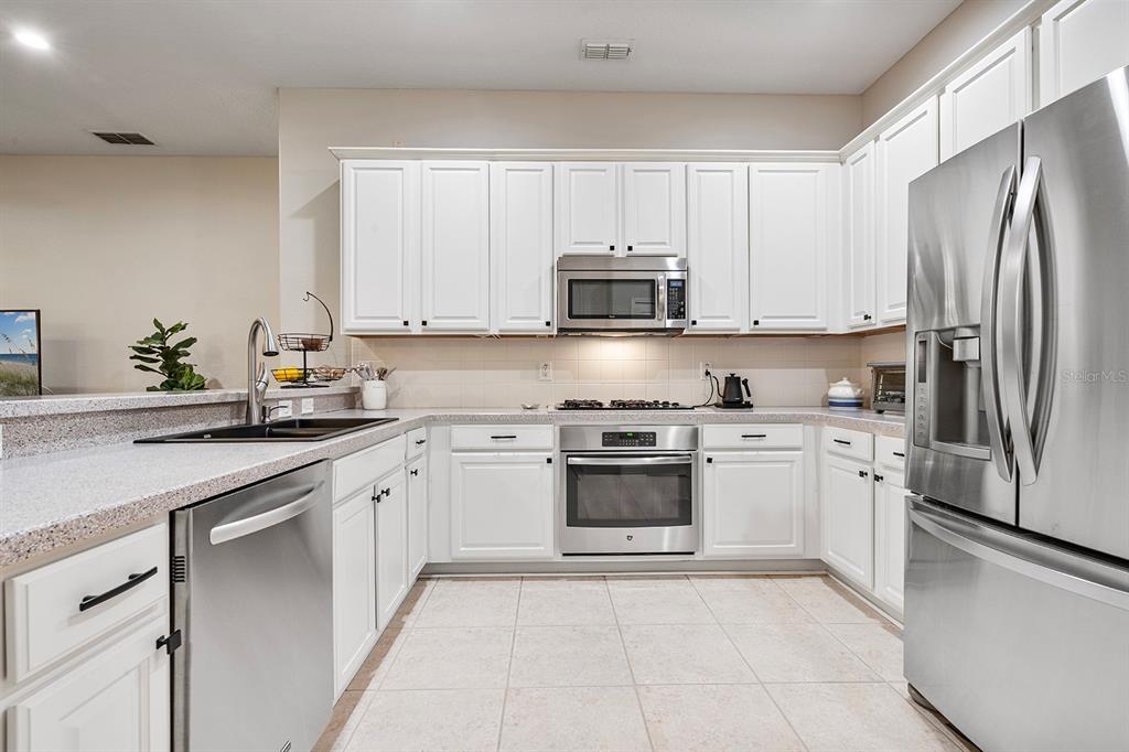 5713 Oak Lake Trail Oviedo, FL 32765 - Photo 17 of 52 a kitchen with stainless steel appliances granite countertop a refrigerator sink and stove