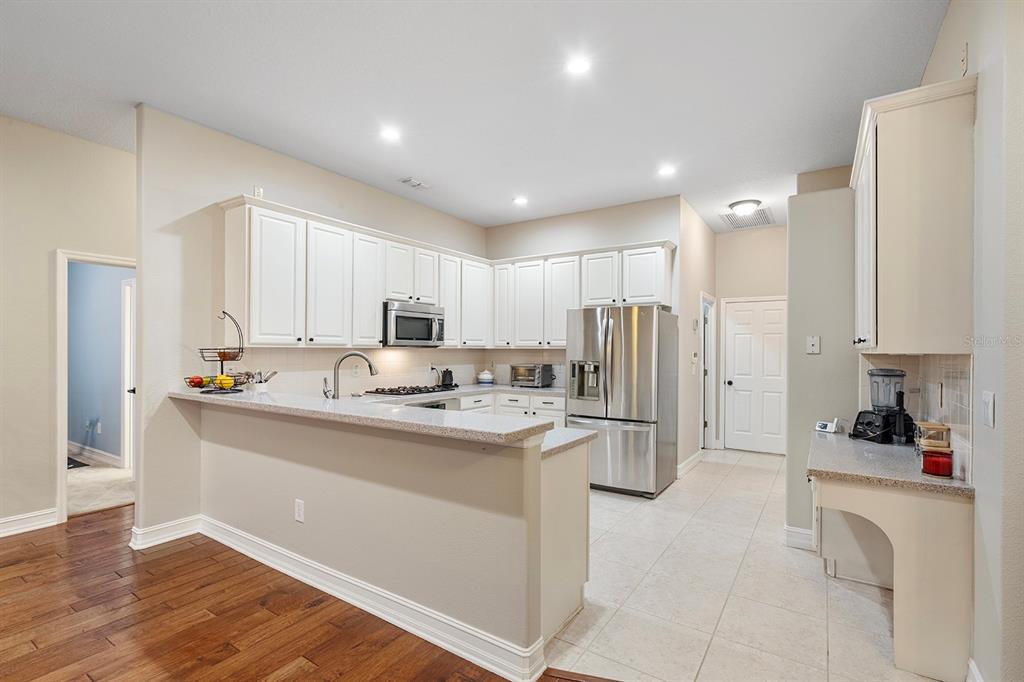 5713 Oak Lake Trail Oviedo, FL 32765 - Photo 18 of 52 a kitchen with stainless steel appliances granite countertop a refrigerator sink and white cabinets