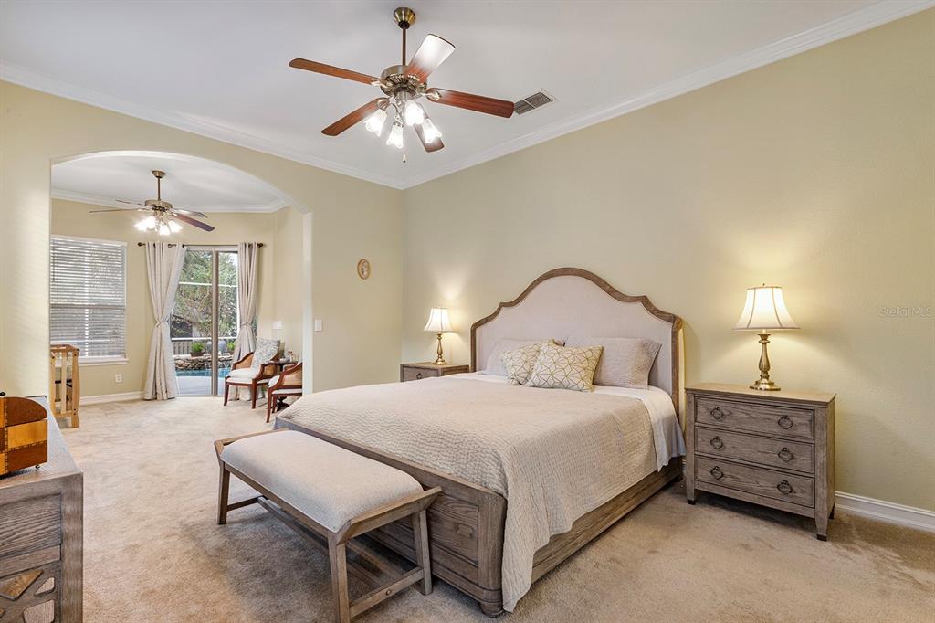 5713 Oak Lake Trail Oviedo, FL 32765 - Photo 19 of 52 a bedroom with a bed a chandelier and a couch