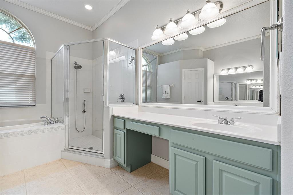 5713 Oak Lake Trail Oviedo, FL 32765 - Photo 25 of 52 a bathroom with a sink a large mirror and a shower