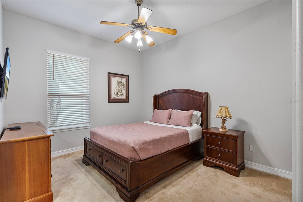 5713 Oak Lake Trail Oviedo, FL 32765 - Photo 26 of 52 a bedroom with a bed and a chandelier