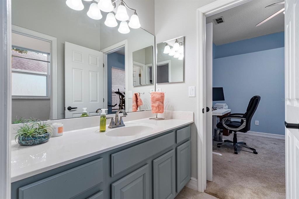 5713 Oak Lake Trail Oviedo, FL 32765 - Photo 27 of 52 a bathroom with a sink a large mirror and a window
