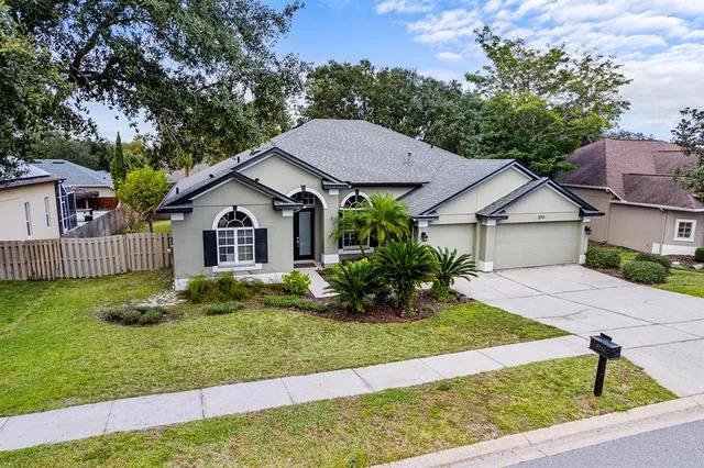 a view of house with backyard and garden