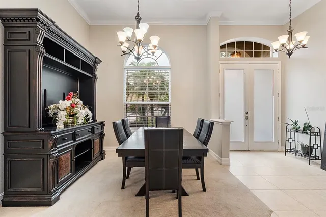a view of a dining room with furniture and chandelier