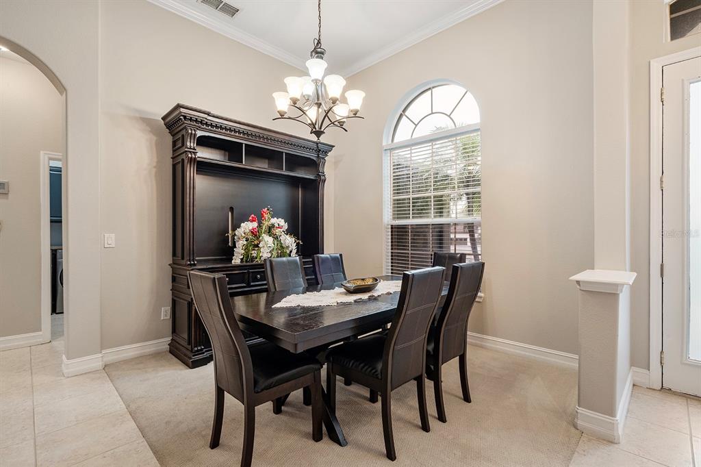 5713 Oak Lake Trail Oviedo, FL 32765 - Photo 7 of 52 a dining room with furniture chandelier and a chandelier