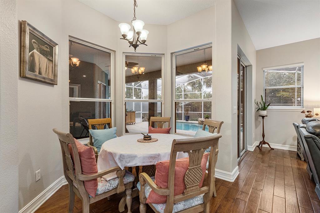 5713 Oak Lake Trail Oviedo, FL 32765 - Photo 10 of 52 a view of a dining room with furniture wooden floor and chandelier
