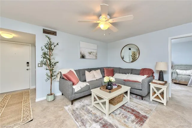 a living room with furniture a rug and a window