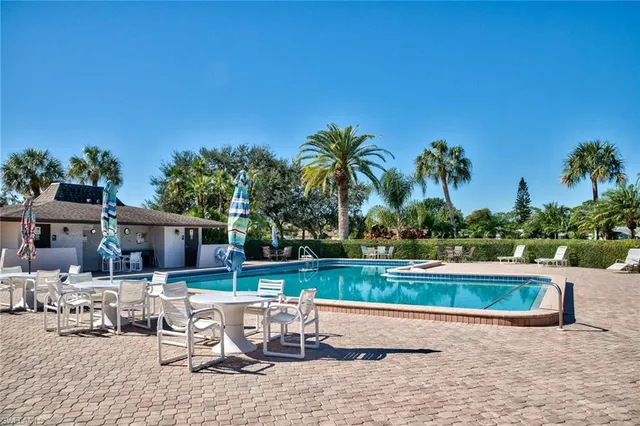 a view of swimming pool with outdoor seating and plants