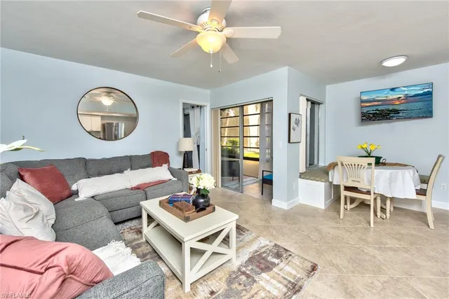 a living room with furniture a rug and a window