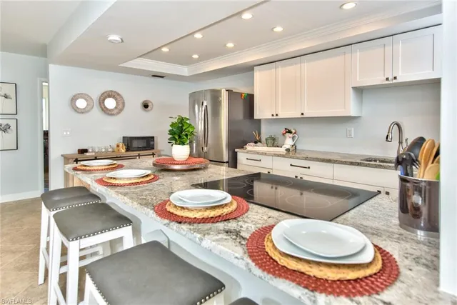 a kitchen with a white dining table and chairs