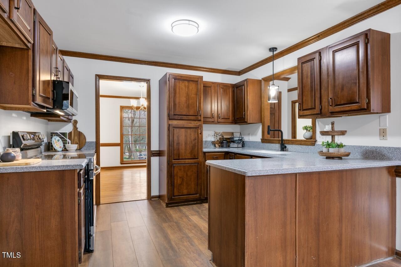 112 Ridgepath Way Cary, NC 27511 - Photo 12 of 38 a kitchen with granite countertop stainless steel appliances and wooden cabinets