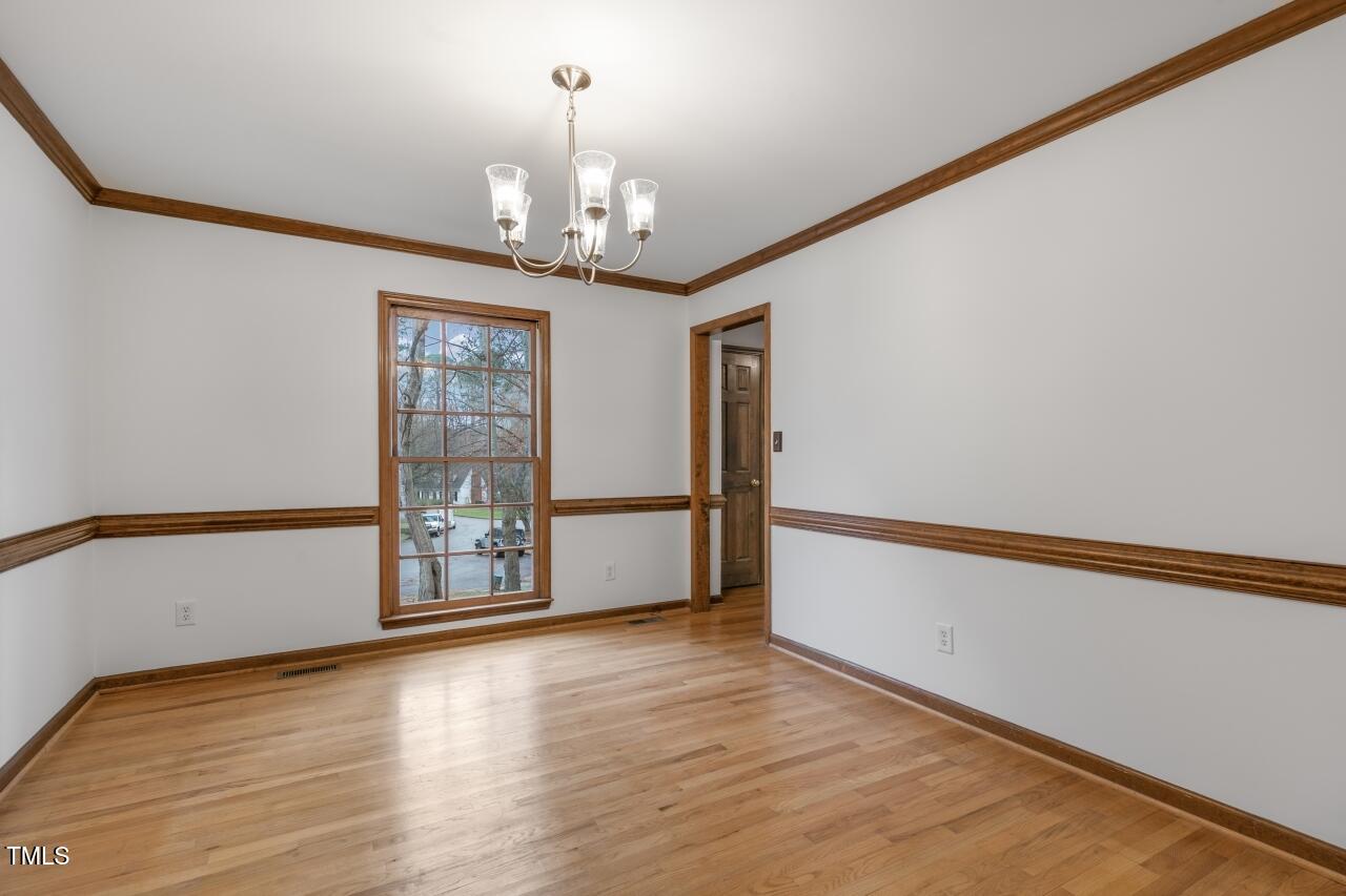 112 Ridgepath Way Cary, NC 27511 - Photo 15 of 38 a view of an empty room with wooden floor and a window