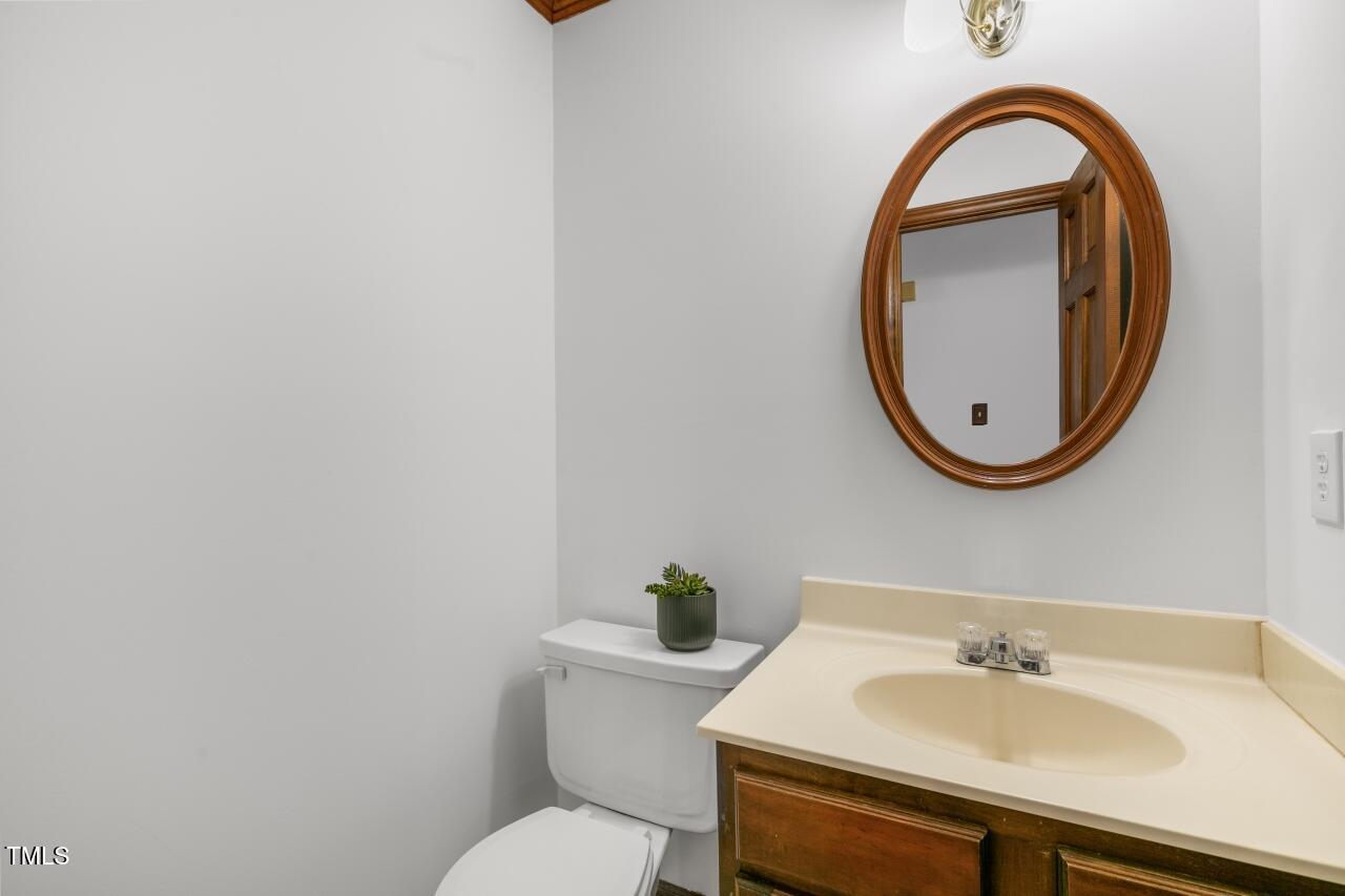 112 Ridgepath Way Cary, NC 27511 - Photo 17 of 38 a bathroom with a sink a mirror and a toilet