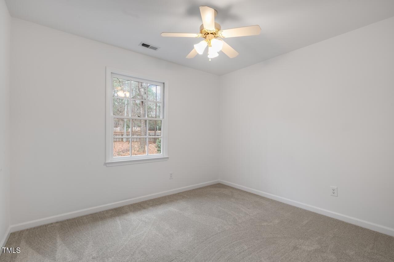 112 Ridgepath Way Cary, NC 27511 - Photo 24 of 38 an empty room with a window and a fan