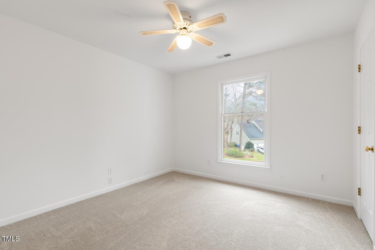 112 Ridgepath Way Cary, NC 27511 - Photo 26 of 38 an empty room with windows and chandelier fan