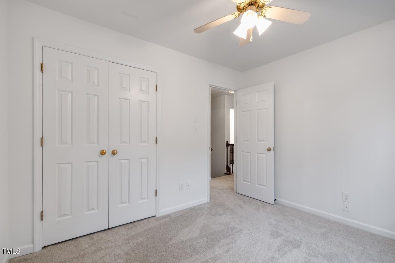 112 Ridgepath Way Cary, NC 27511 - Photo 27 of 38 a view of an empty room and a chandelier fan