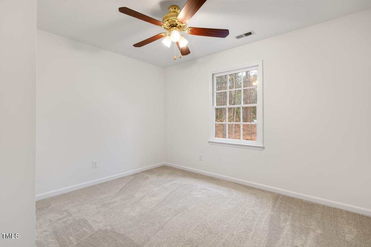 112 Ridgepath Way Cary, NC 27511 - Photo 28 of 38 an empty room with windows and fan