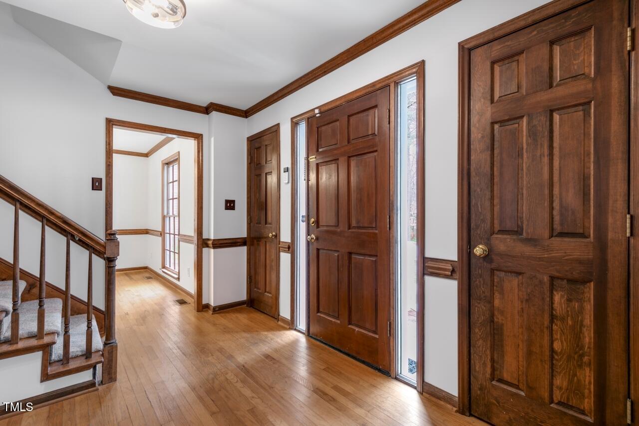 112 Ridgepath Way Cary, NC 27511 - Photo 4 of 38 a view of entryway with wooden floor and stairs