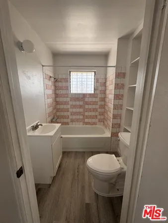 an empty room with windows and stairs