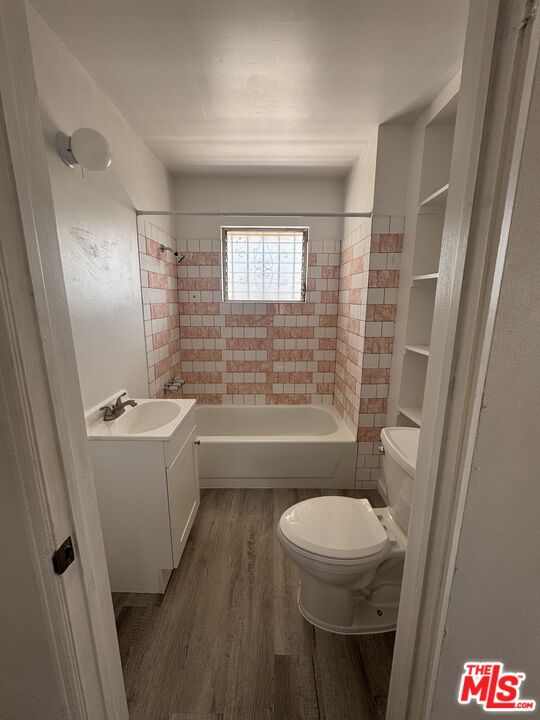 1650 South Rimpau Boulevard Los Angeles, CA 90019 - Photo 8 of 12 a bathroom with a sink a toilet and shower