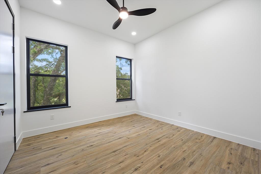 2811 Rodeo Drive Quinlan, TX 75474 - Photo 17 of 35 Spare room with light wood-type flooring, ceiling fan, and recessed lighting