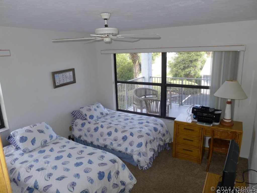 6544 Engram Road, Unit E204 New Smyrna Beach, FL 32169 - Photo 12 of 22 a bedroom with two beds and a window