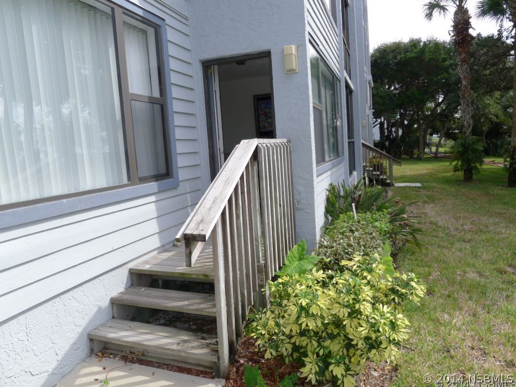 6544 Engram Road, Unit E204 New Smyrna Beach, FL 32169 - Photo 20 of 22 a view of balcony with wooden floor and fence