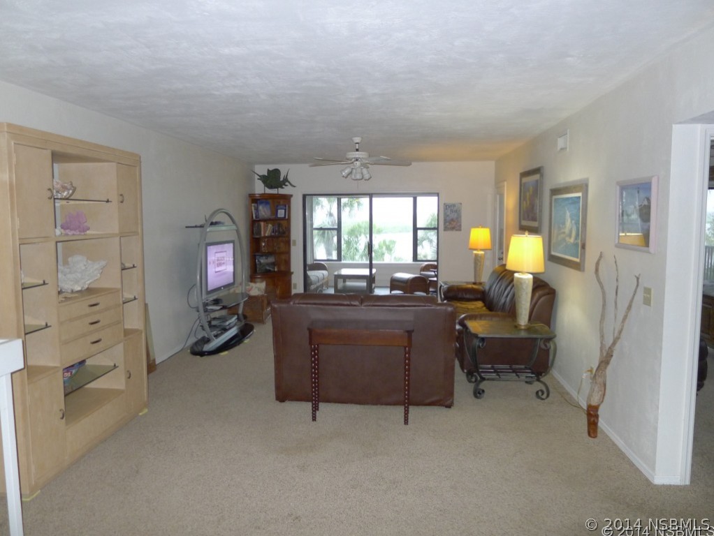 6544 Engram Road, Unit E204 New Smyrna Beach, FL 32169 - Photo 7 of 22 a living room with furniture and a large window