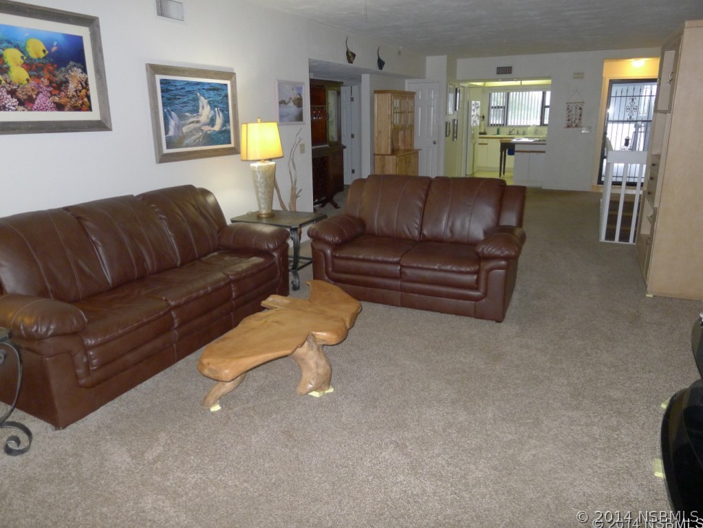6544 Engram Road, Unit E204 New Smyrna Beach, FL 32169 - Photo 8 of 22 a living room with furniture and wooden floor