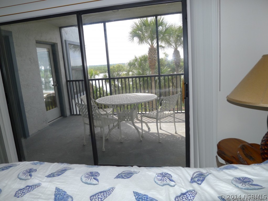 6544 Engram Road, Unit E204 New Smyrna Beach, FL 32169 - Photo 10 of 22 a bedroom with a bed and a window