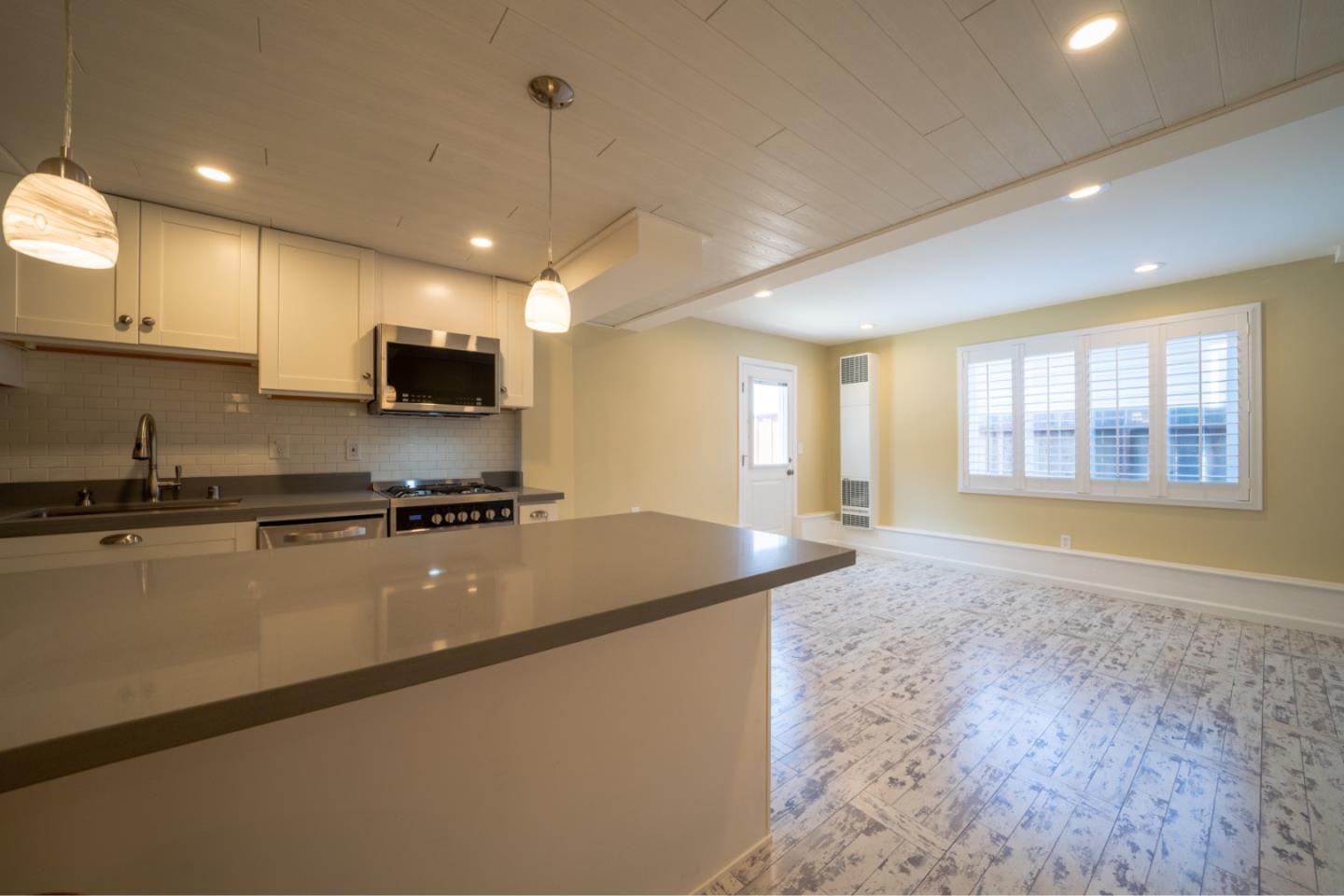 a kitchen with stainless steel appliances granite countertop a sink a stove and a refrigerator