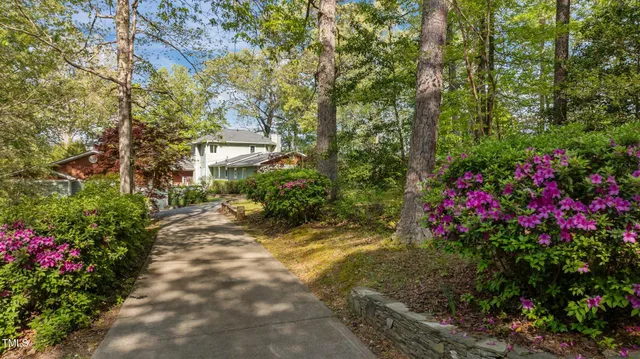 a view of an empty room with window and fireplace